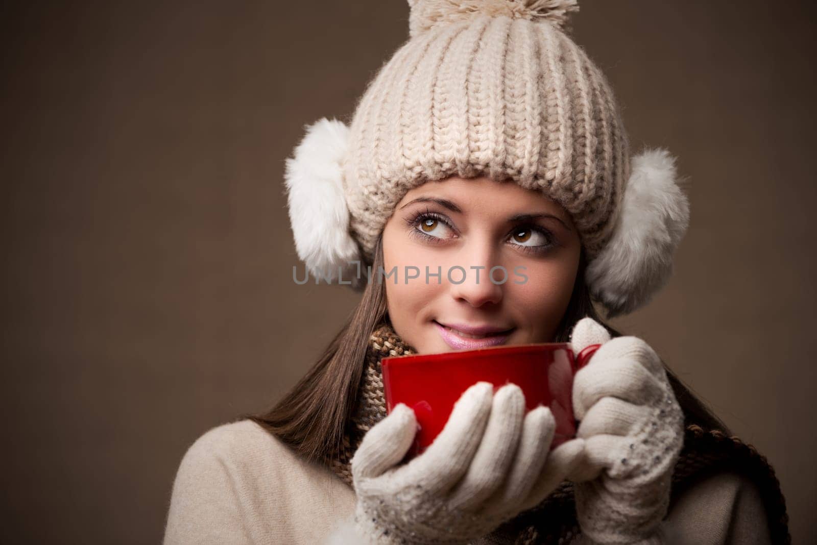 Portrait of beautiful winter woman with a cup of coffee or tea