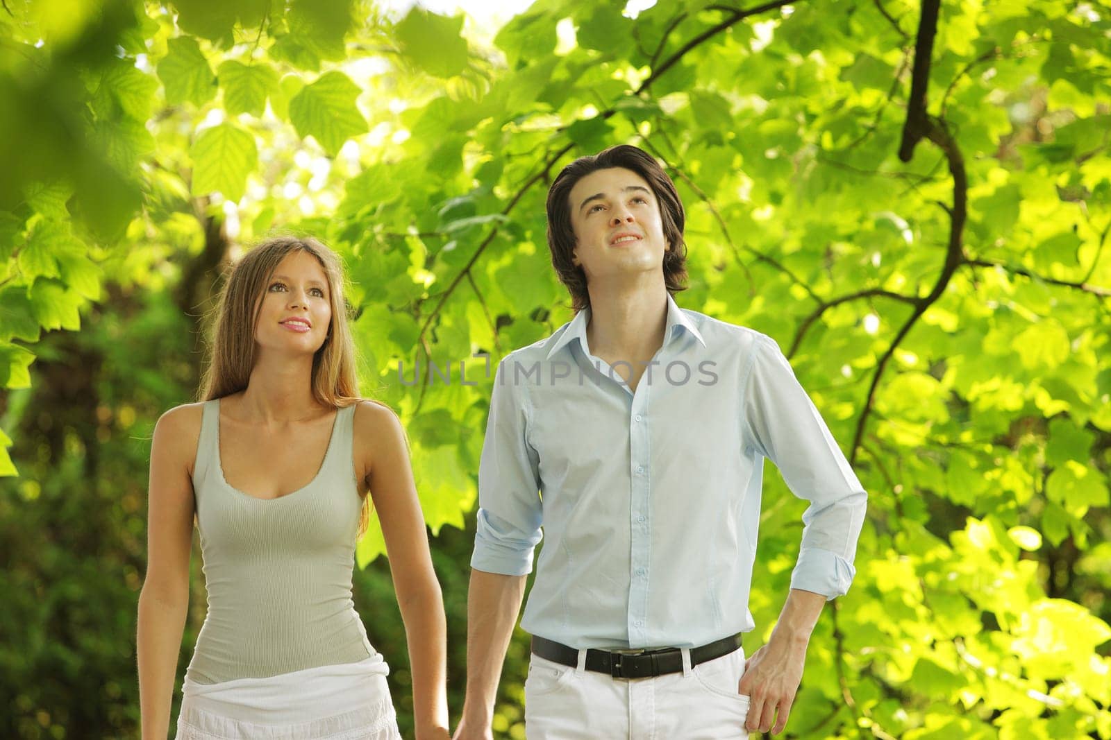 a young couple in love walking in the park