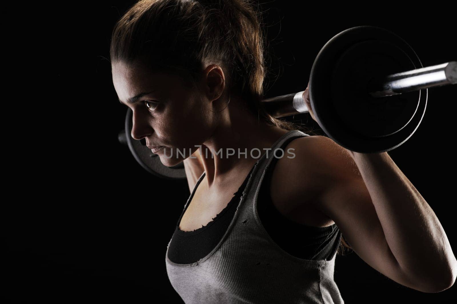Young woman lifting weights