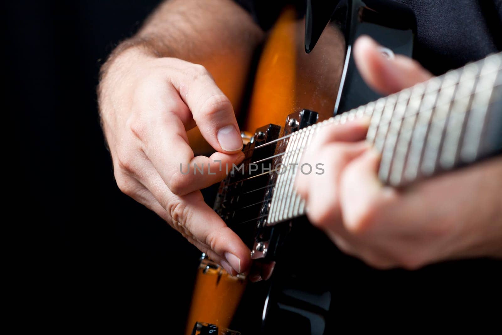 Close up on hands playing on electric guitar