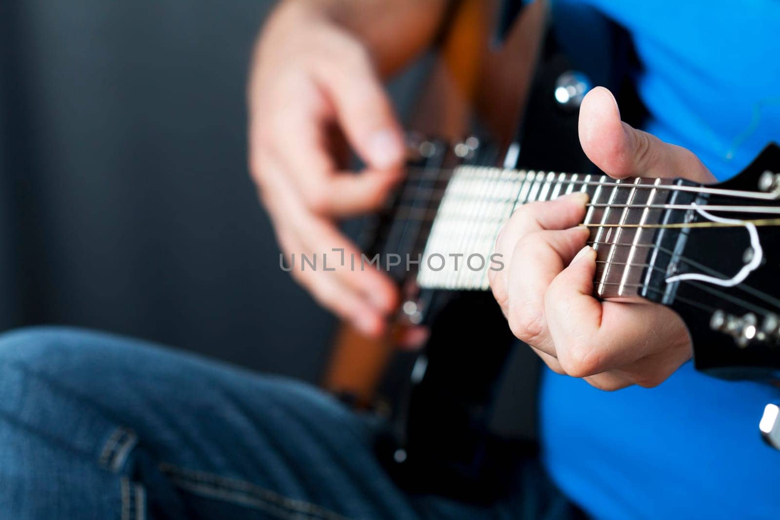Close up on hands playing on electric guitar
