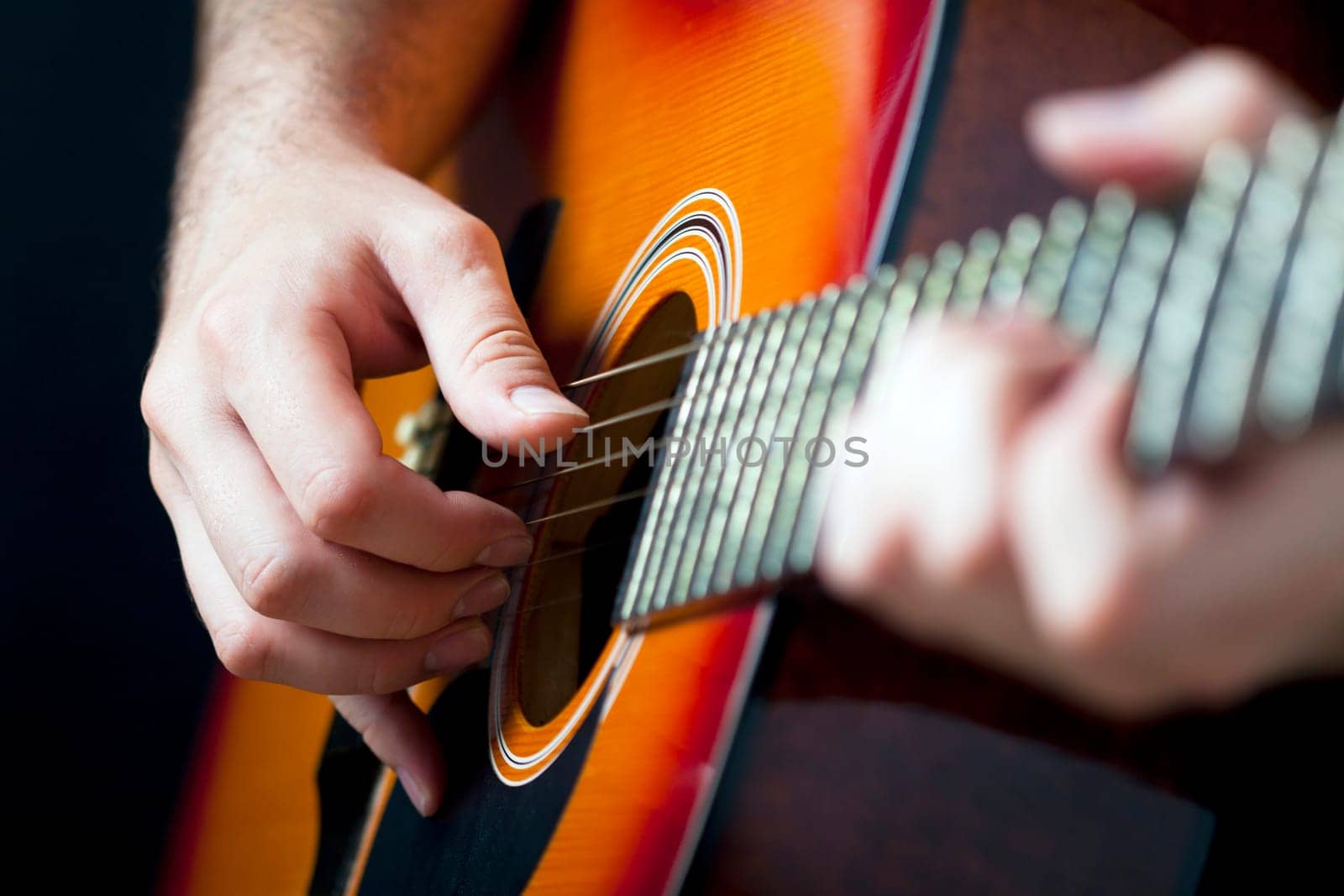 Close up on hands playing on folk guitar