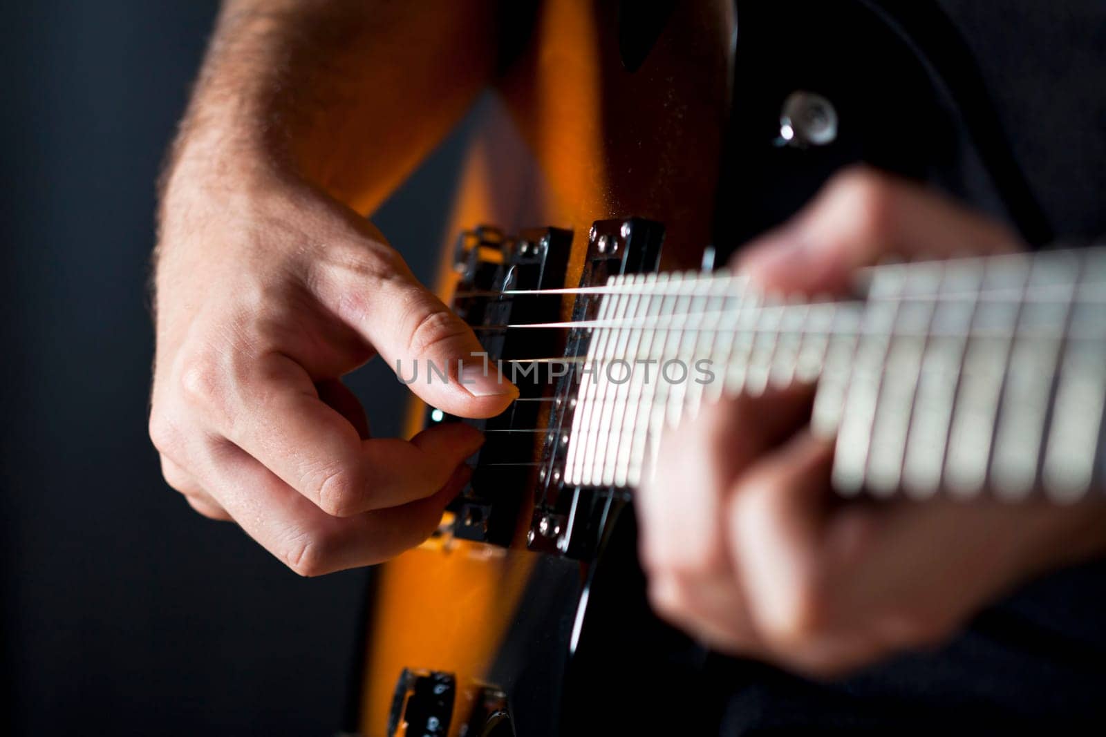 Close up on hands playing on electric guitar