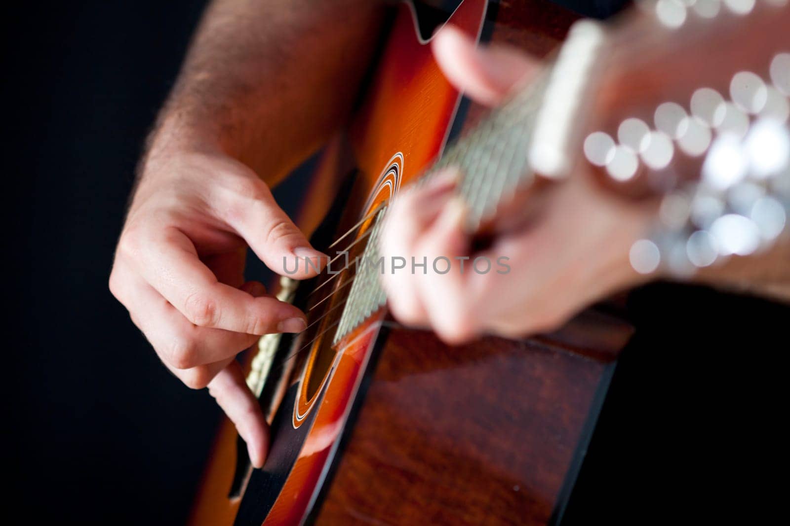 Close up on hands playing on folk guitar