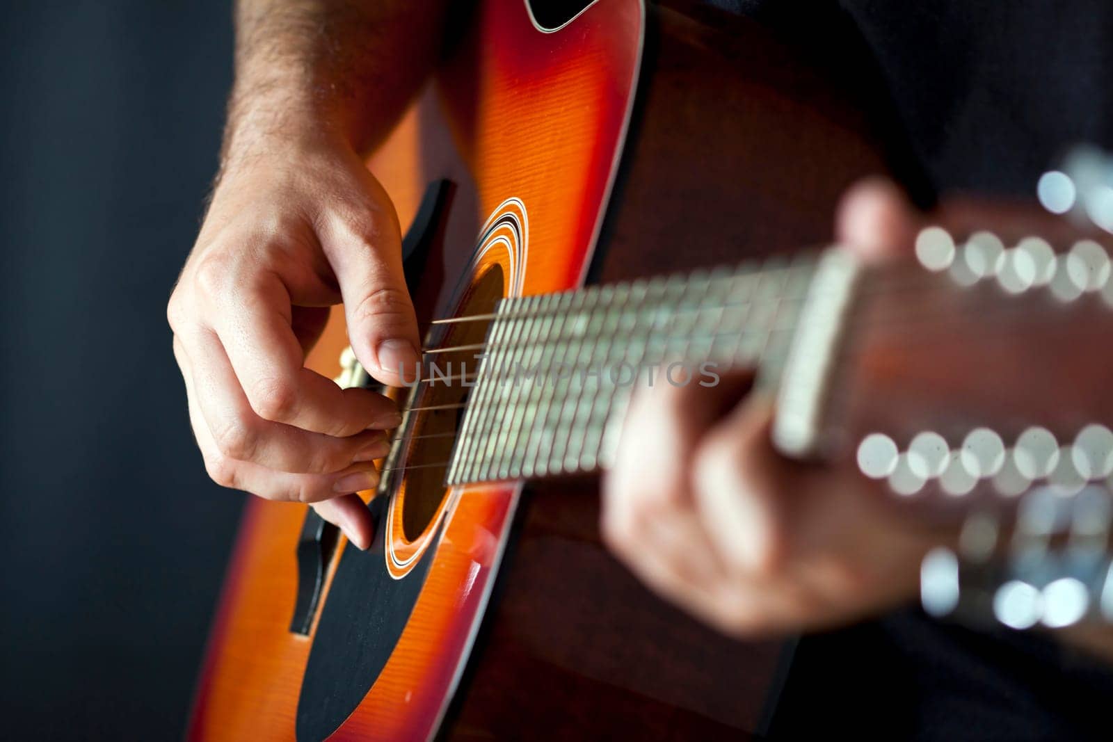 Close up on hands playing on folk guitar