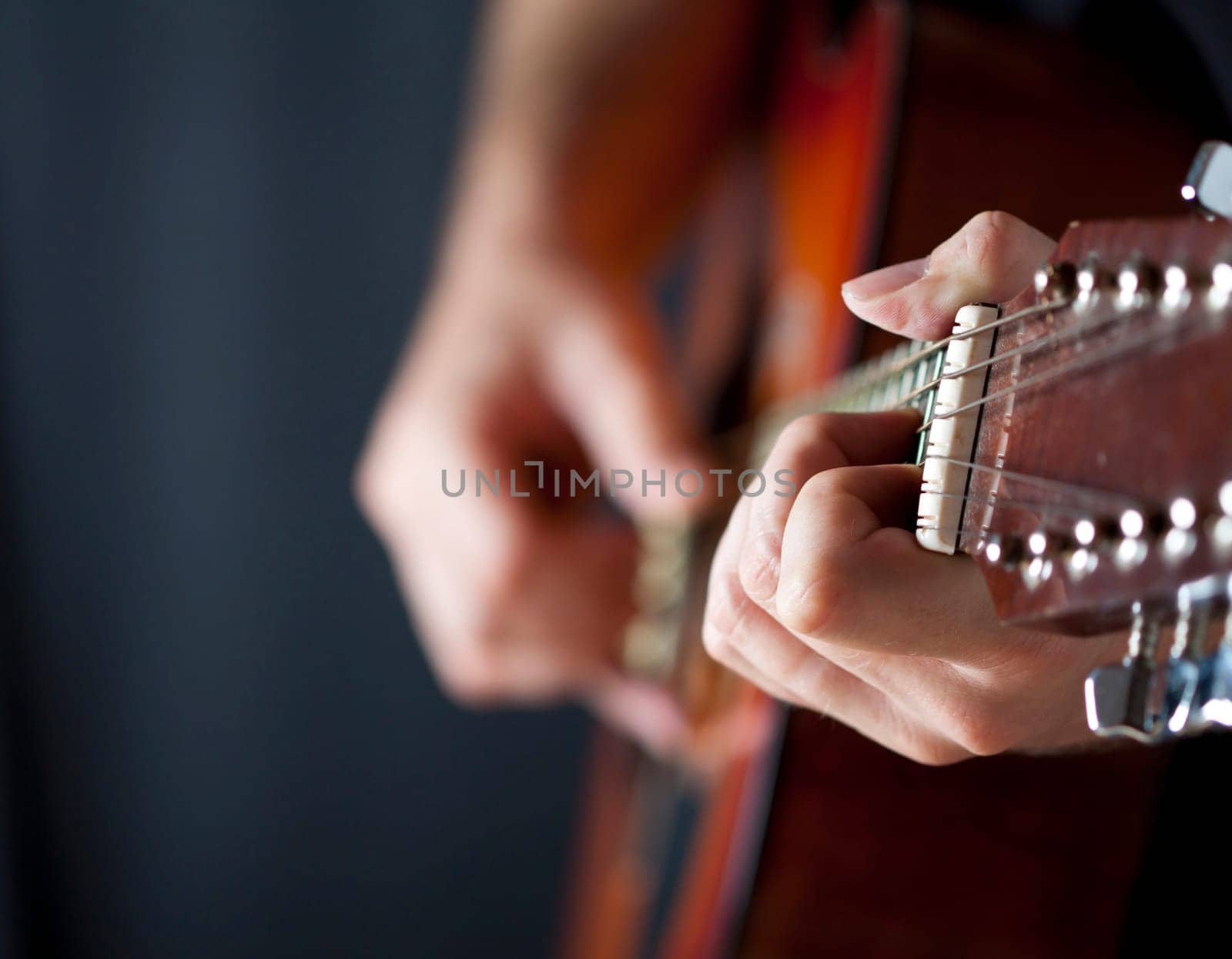 Close up on hands playing on folk guitar