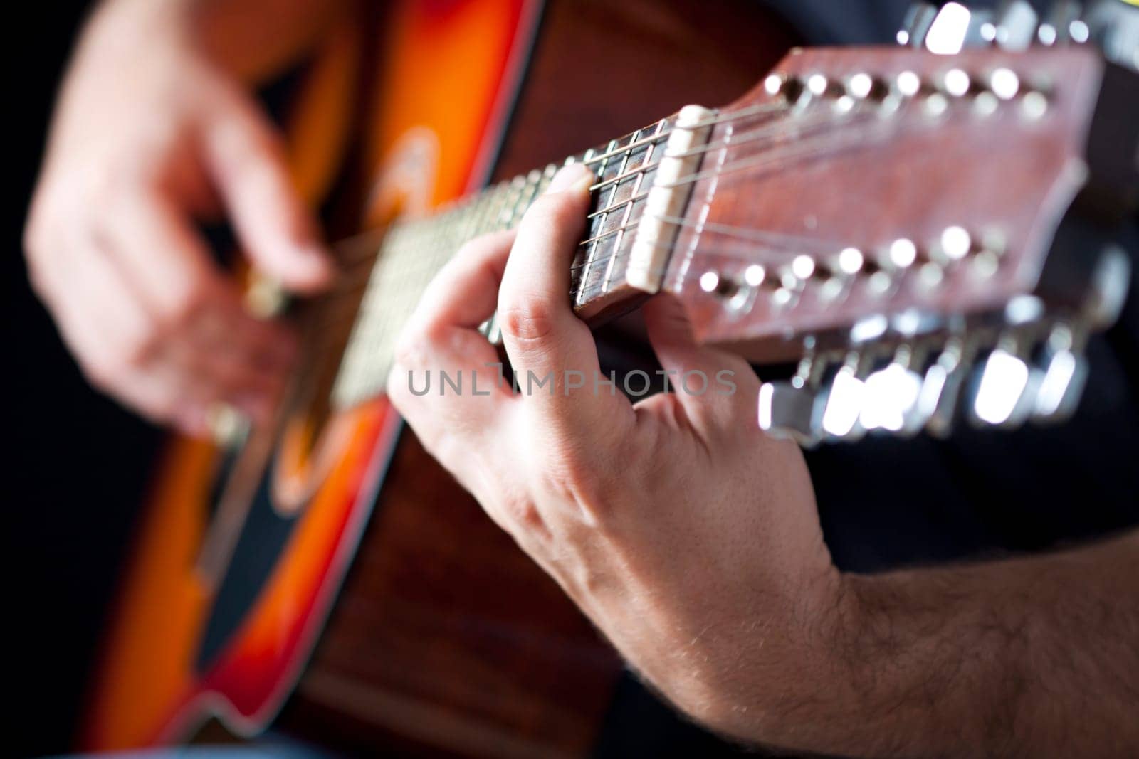 Close up on hands playing on folk guitar