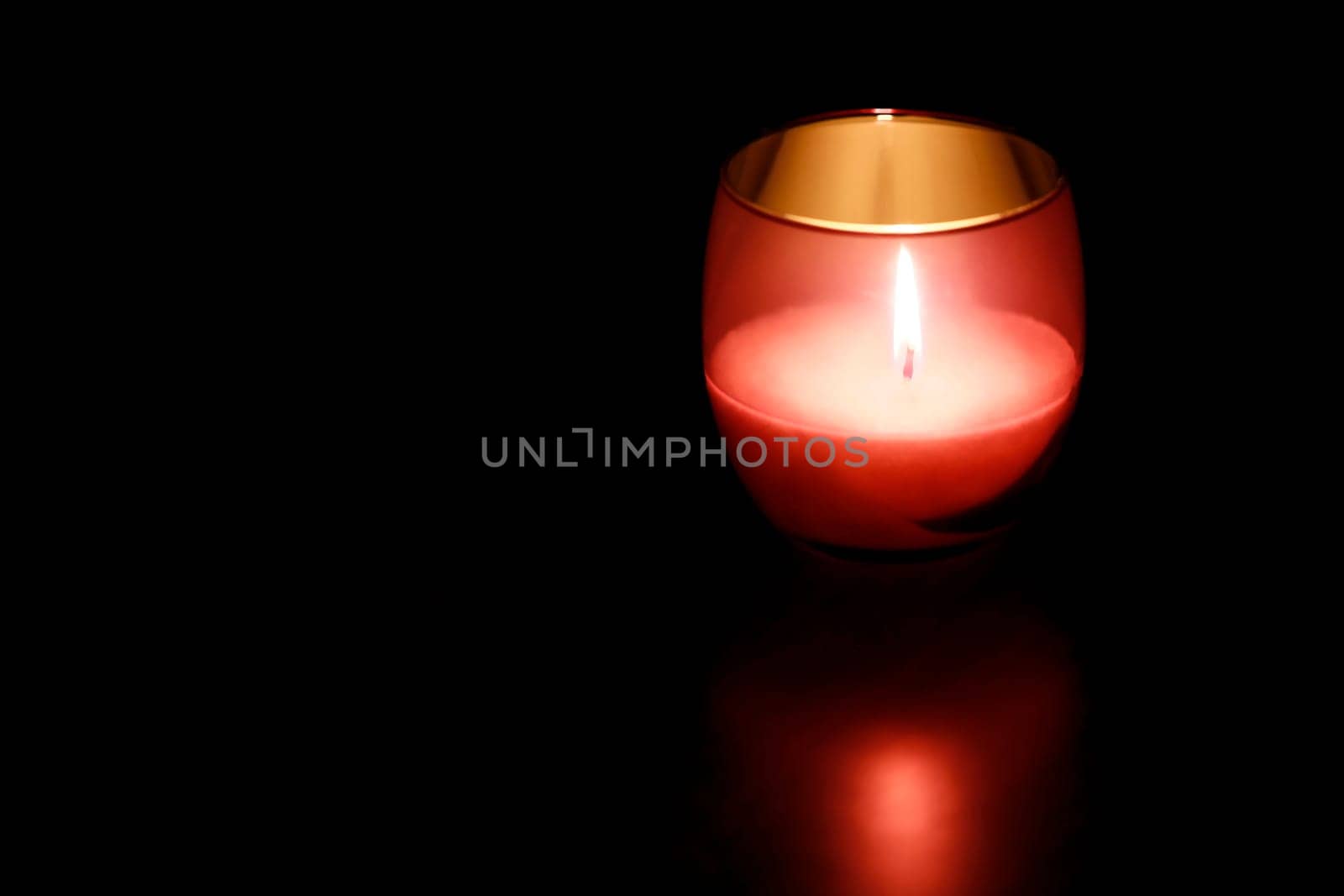 Red candle glass at night