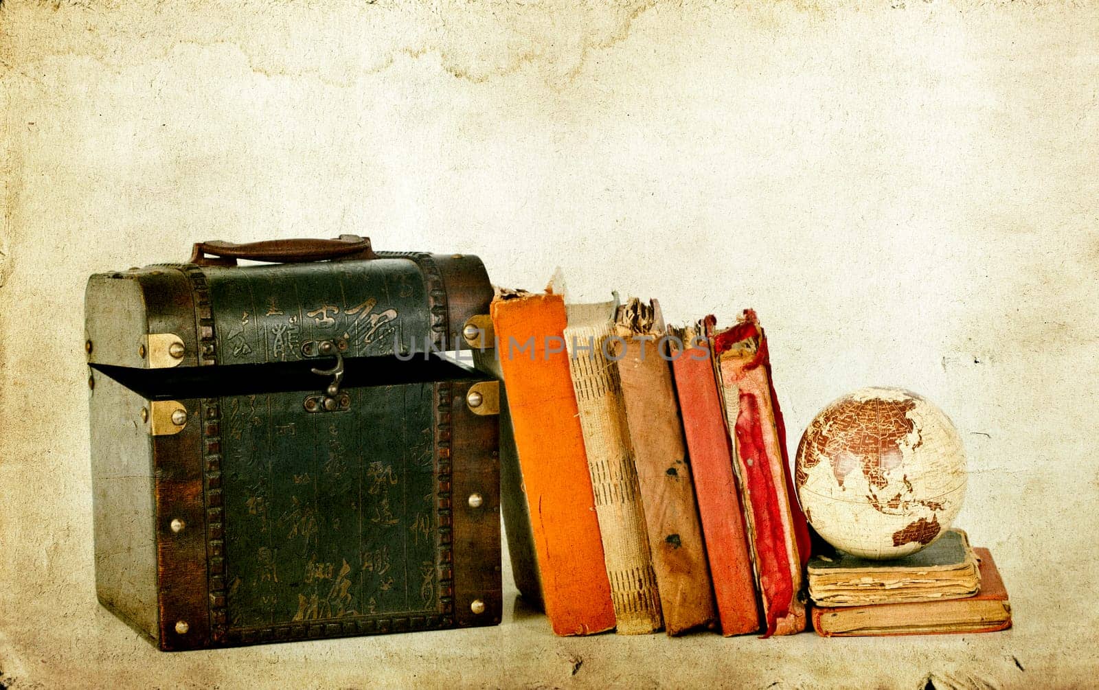 Vintage photo of old books, treasure box and Earth globe