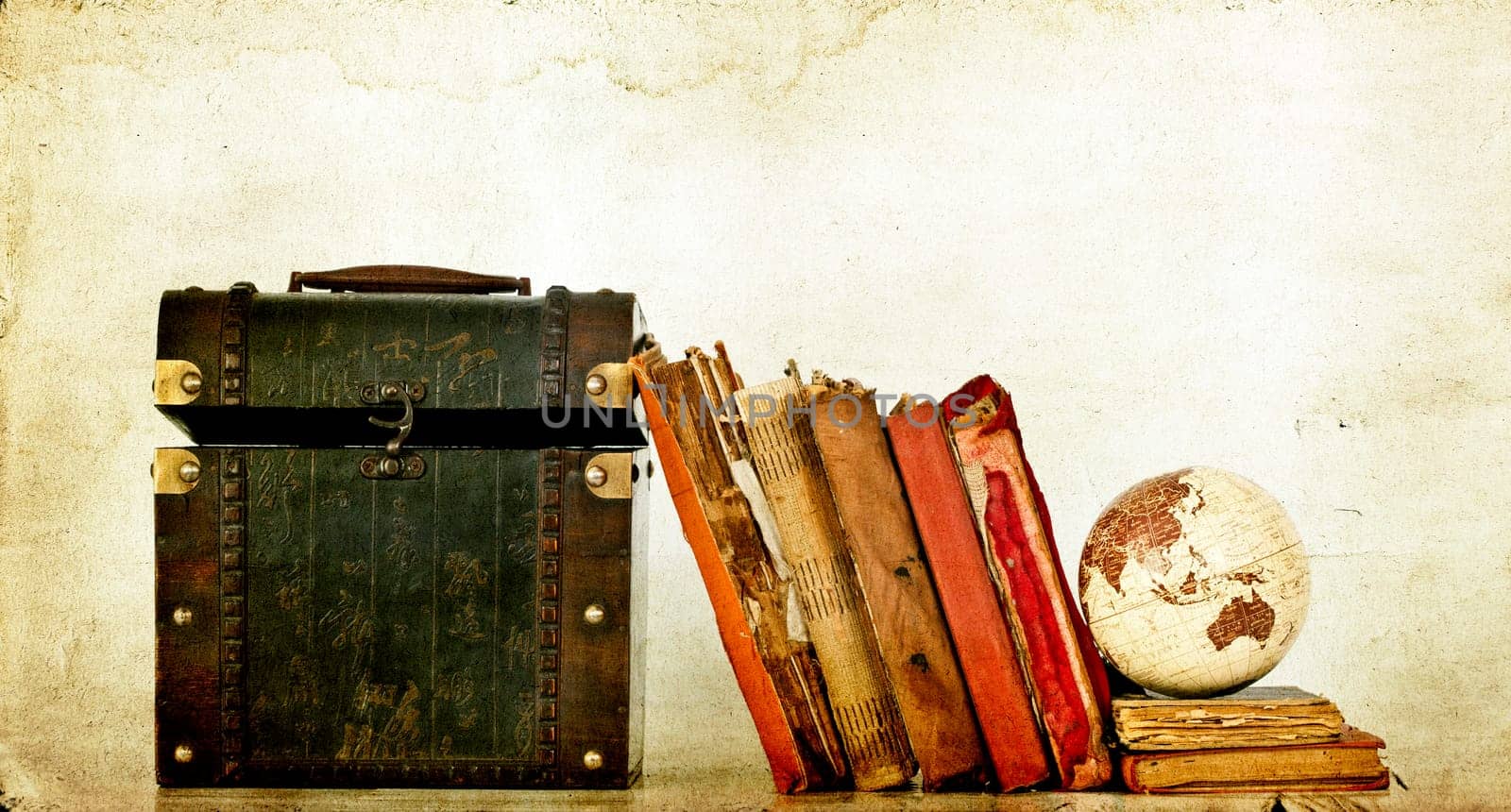Vintage photo of old books, treasure box and Earth globe