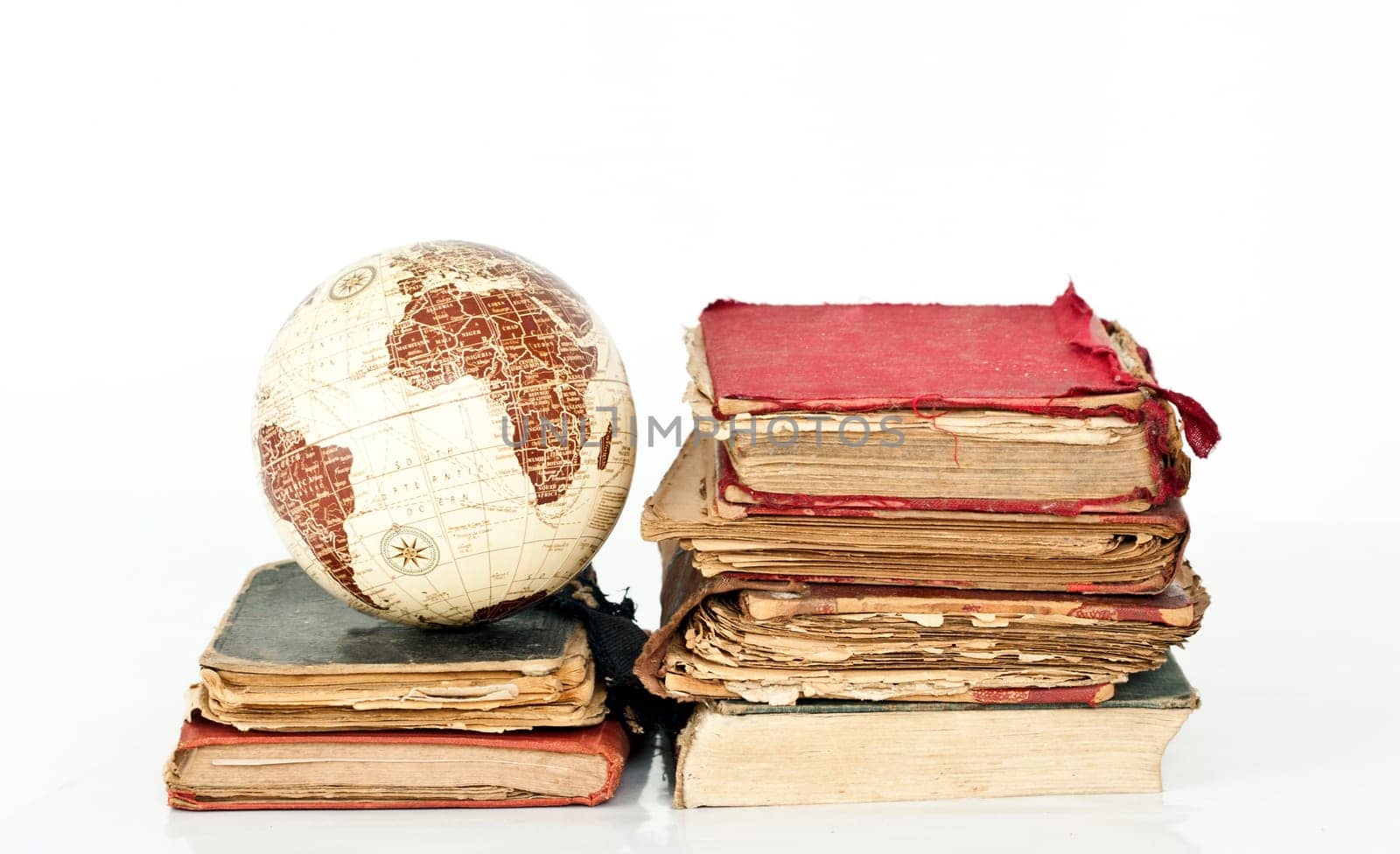 Old books and globe earth isolated on white