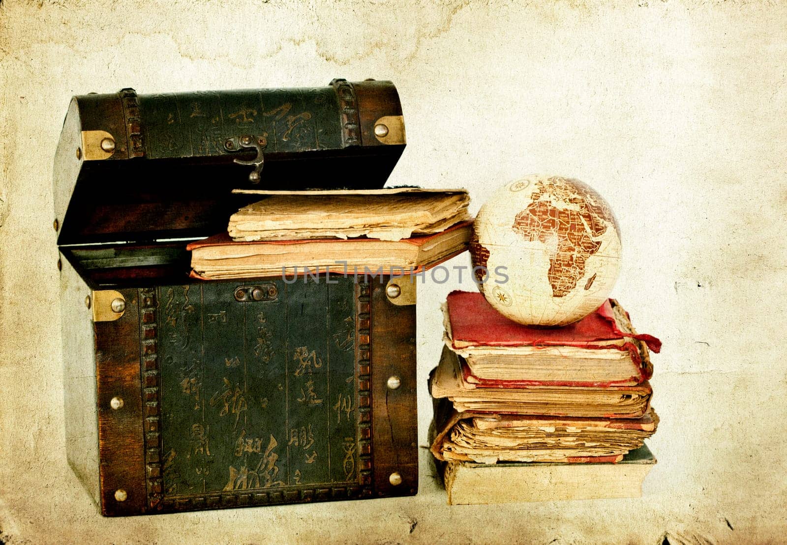 Vintage photo of old books, treasure box and Earth globe