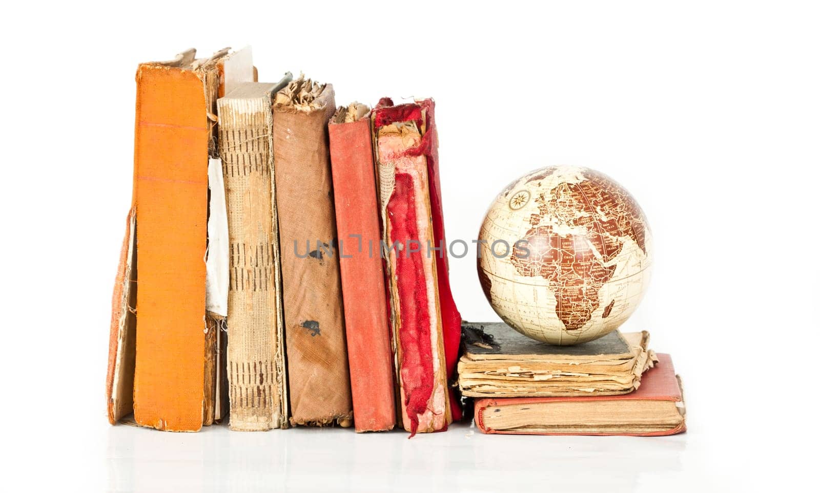Old books and globe earth isolated on white