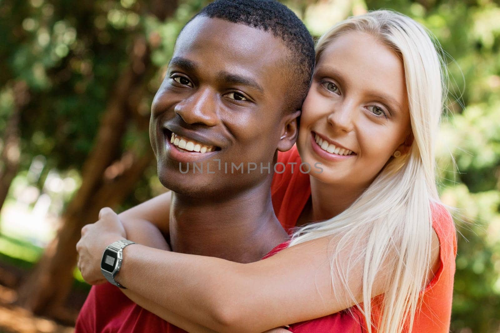 Multicultural young couple in love in summer outdoor leisure fun happy