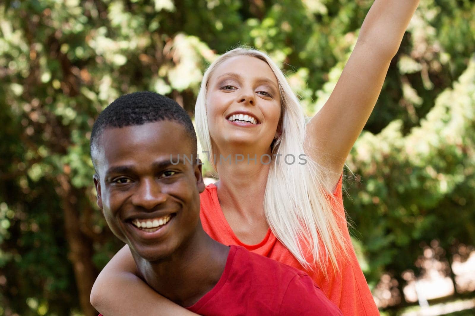 Multicultural young couple in love in summer outdoor leisure fun happy