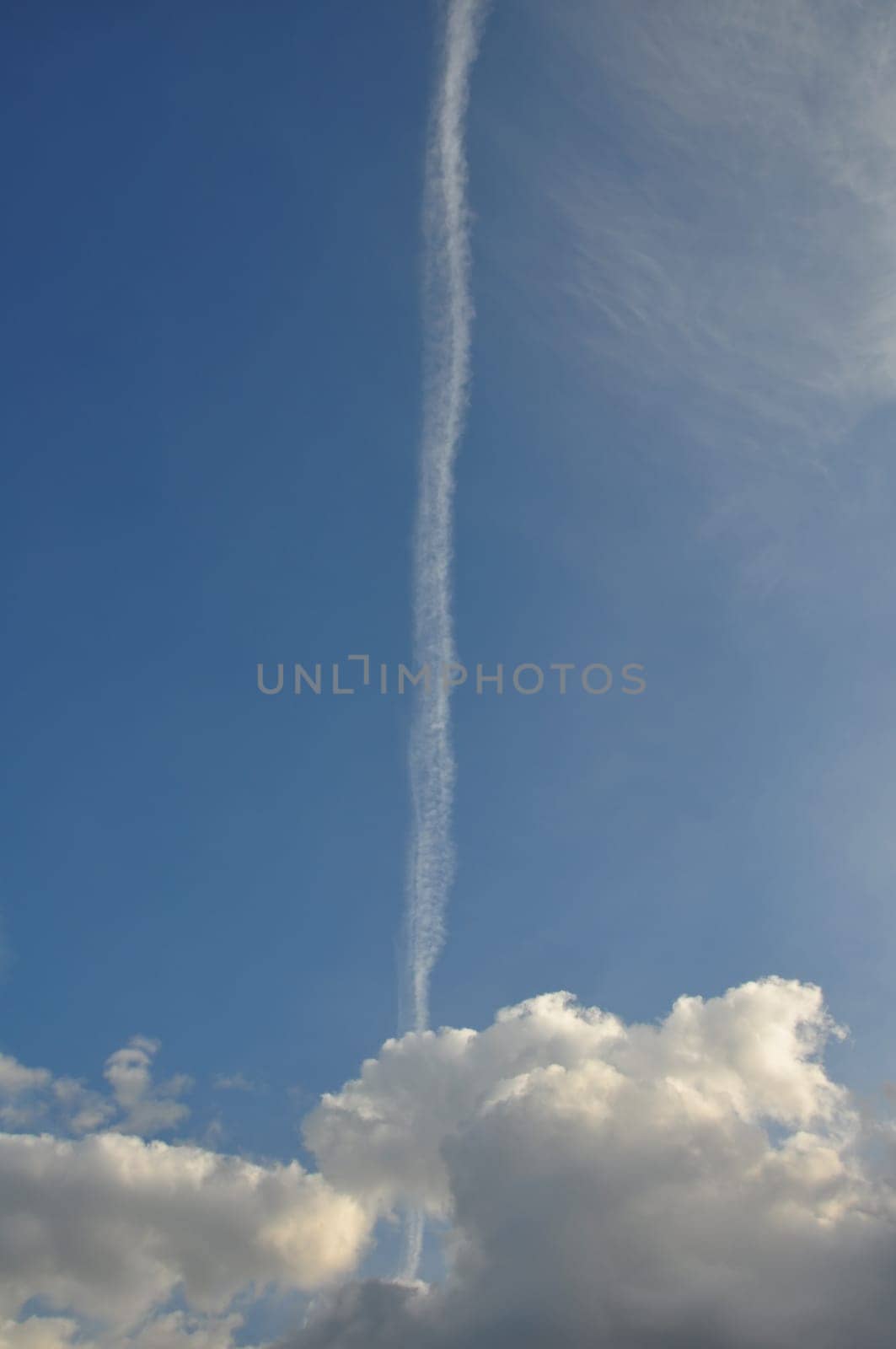 Blue sky airplane smoke trail and clouds. Abstract travel background.