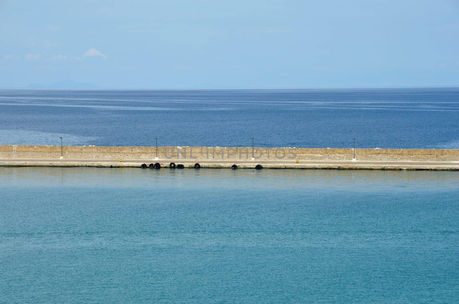 Jetty wall sea and sky horizon abstract background.