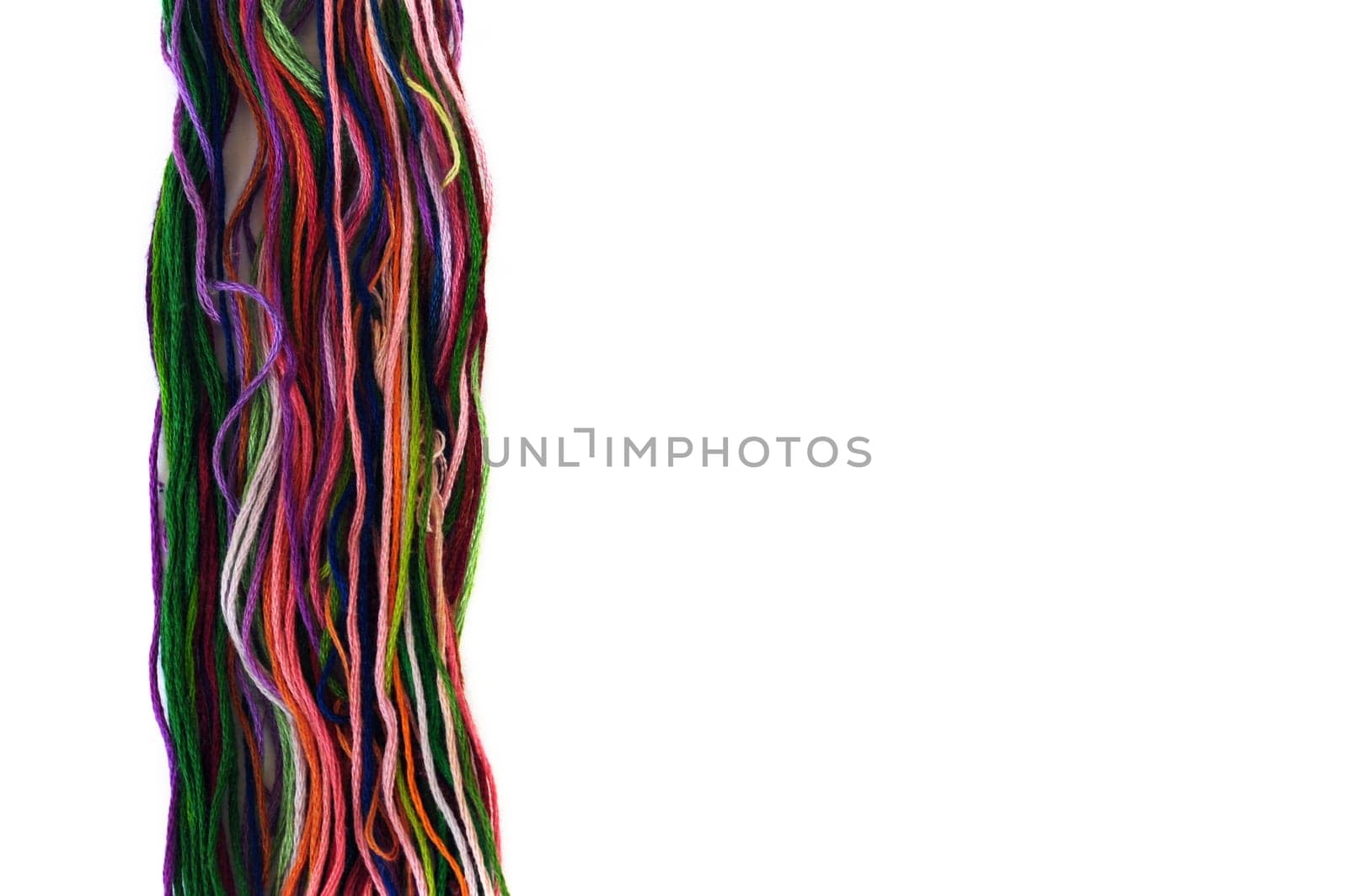 Multicolor sewing threads macro on white background.