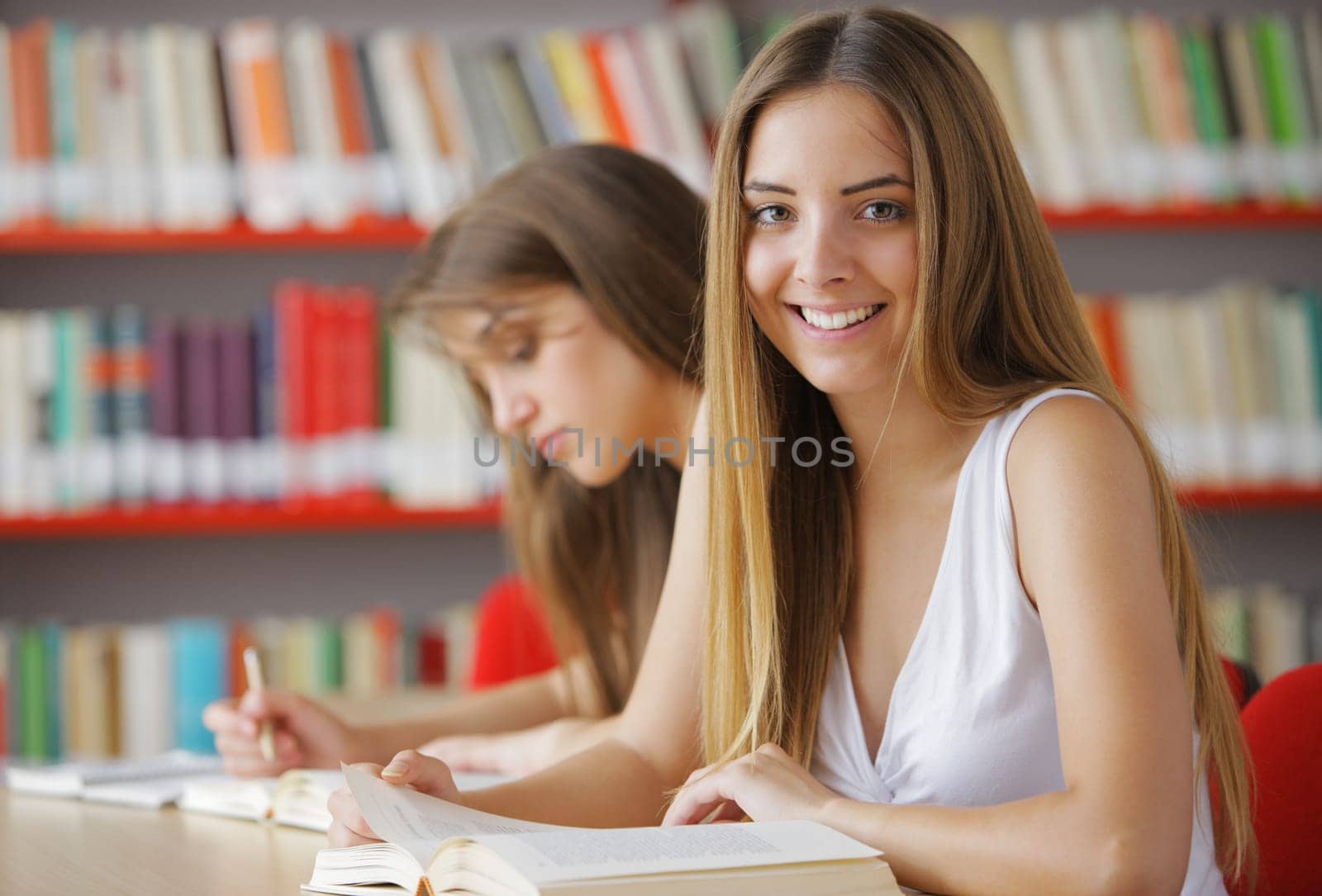 Female College Students in a Library