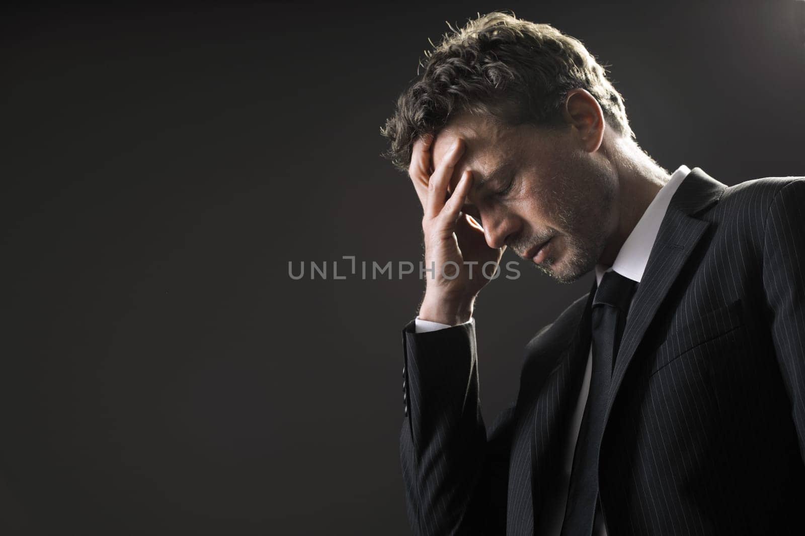 Mature businessman stressed and worried look down
