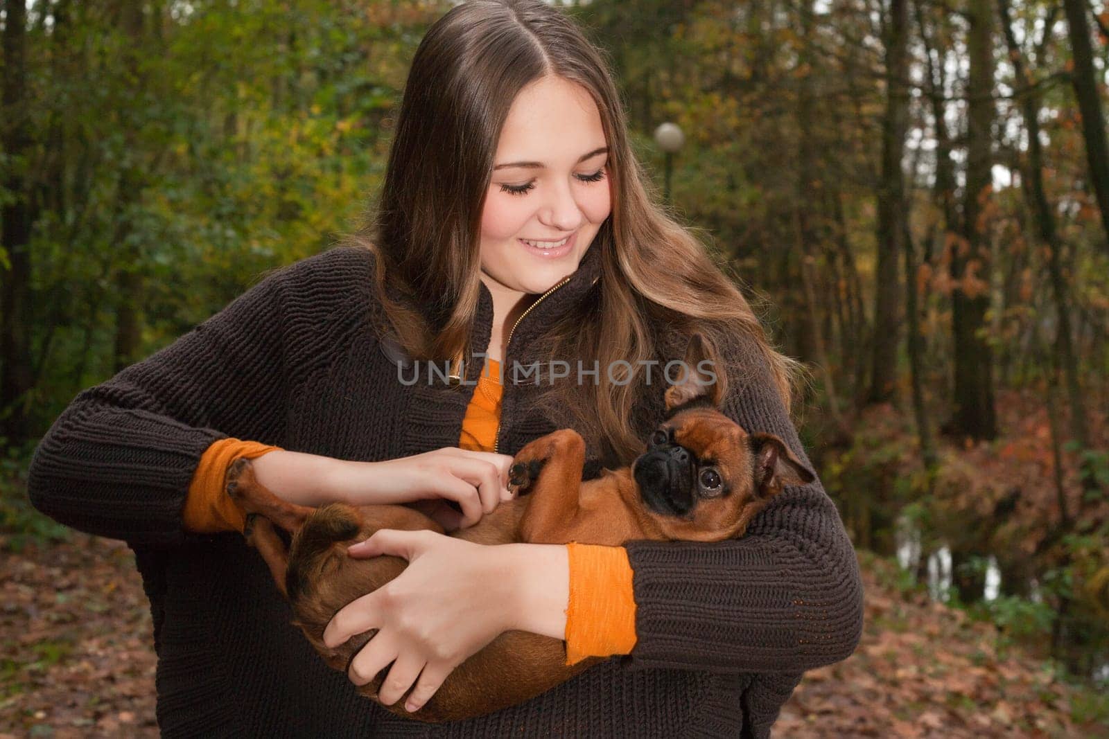 Young teenage girl is having a nice time in the cold november