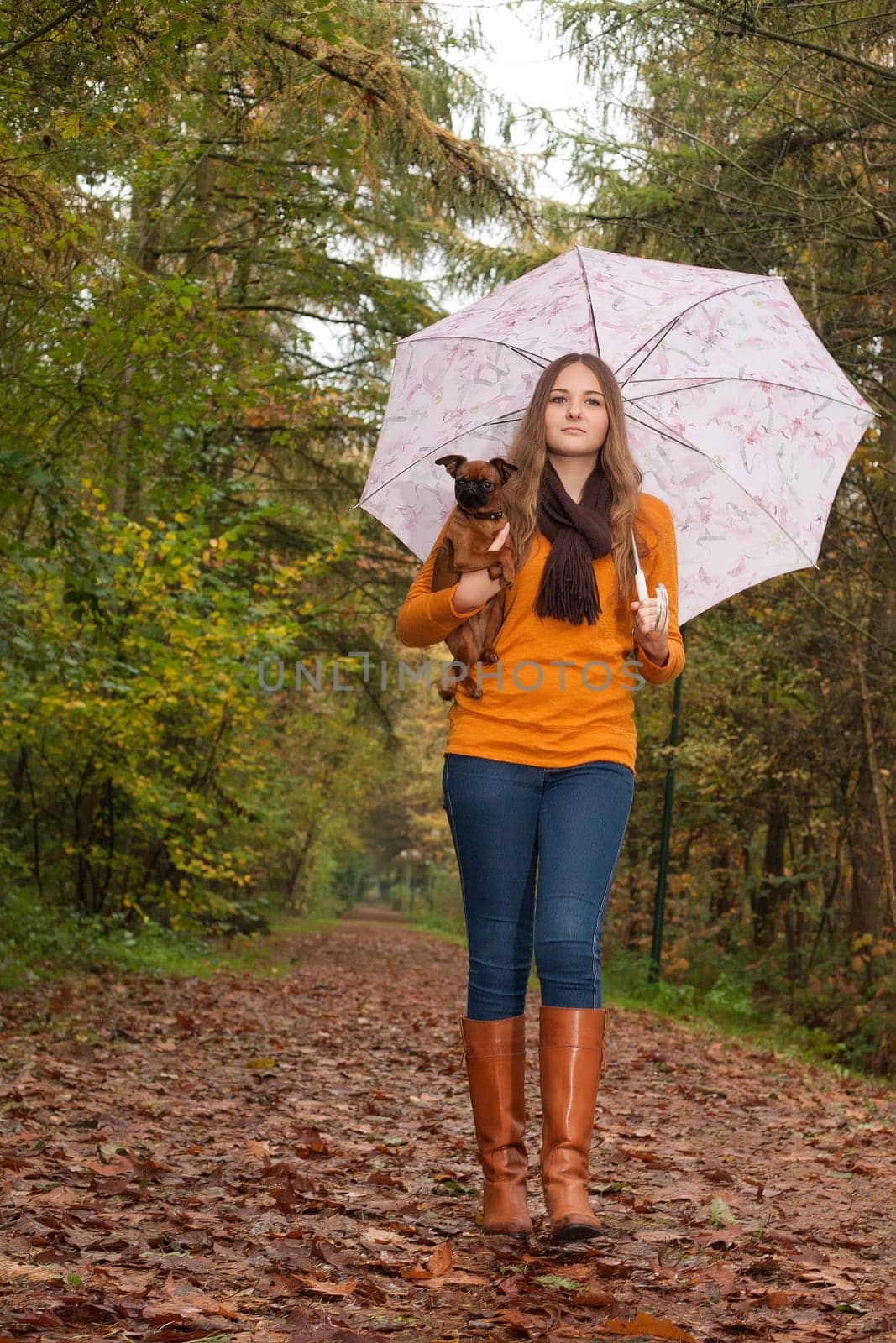 Young teenage girl is having a nice time in the cold november