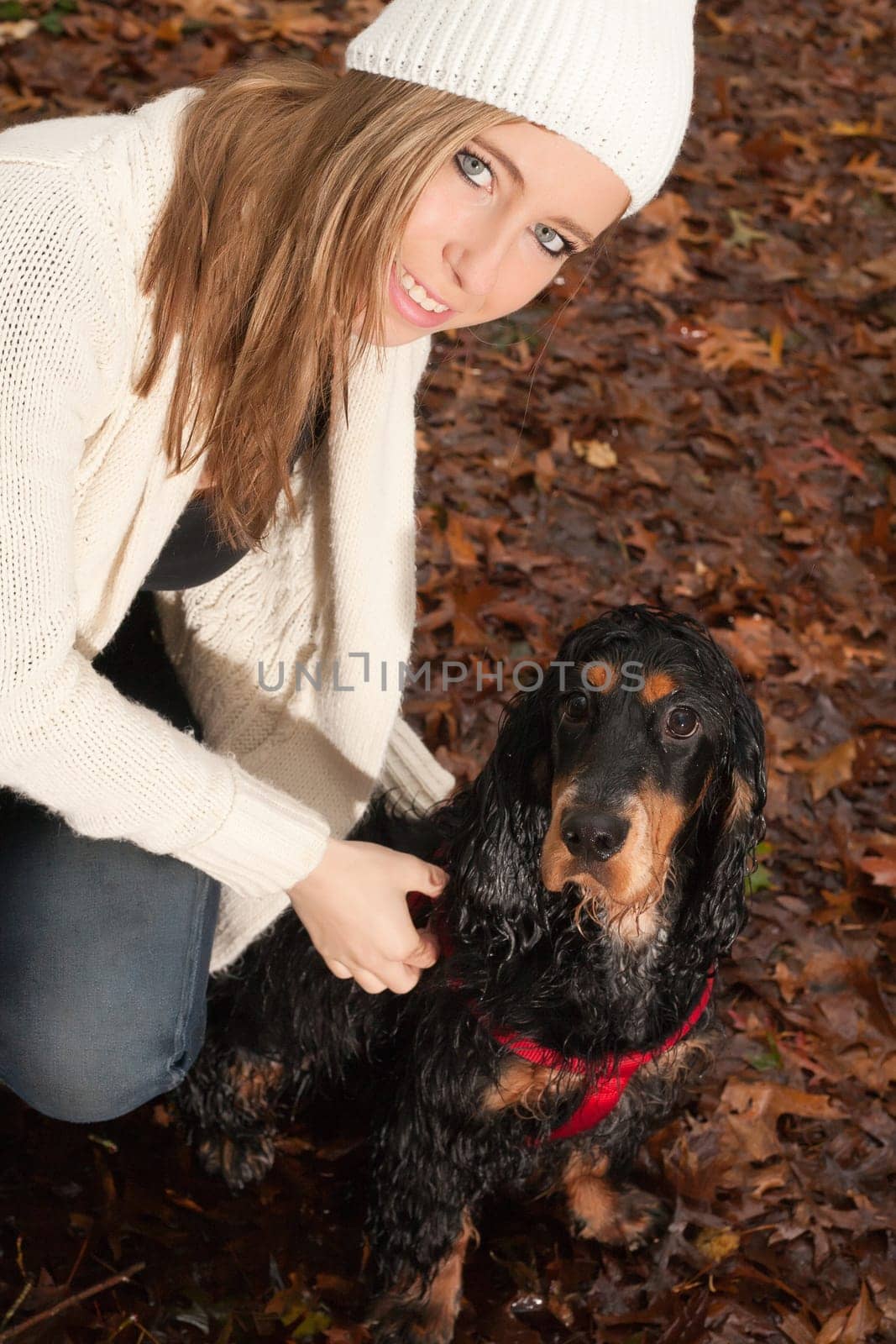 Girl and her dog are having a wet time in the rain