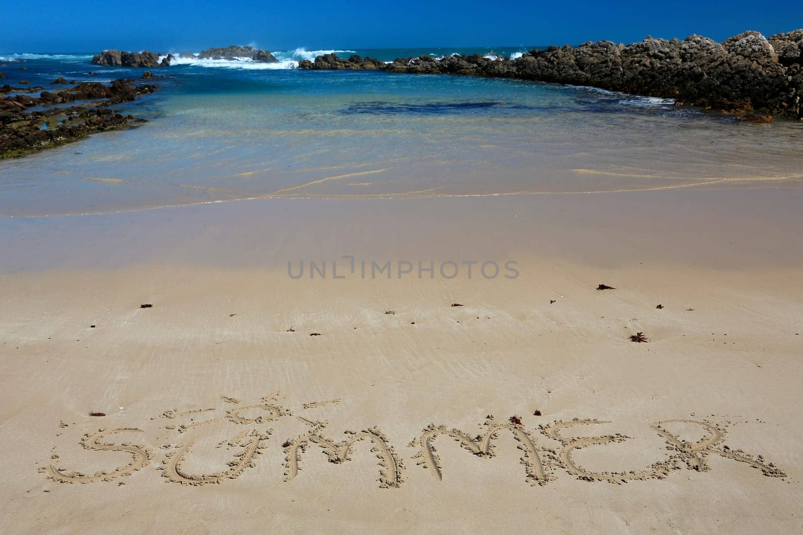 Clean sand and blue sea water at the coast in South Africa