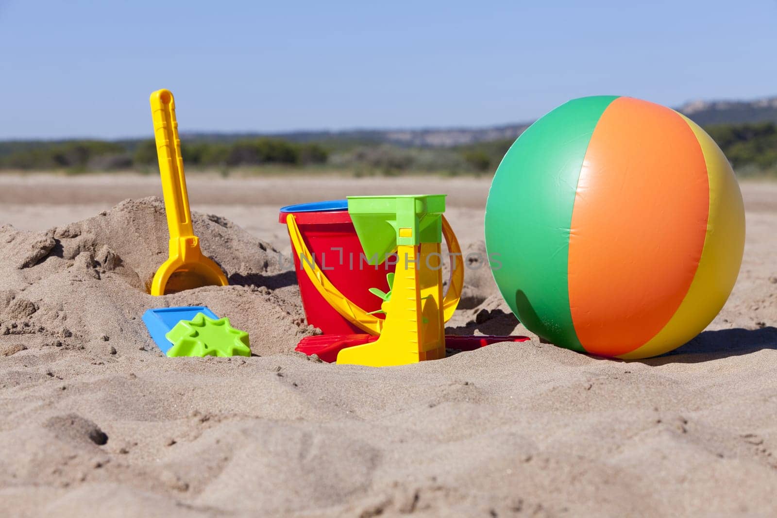 Colorful beach toys on the sandy beach