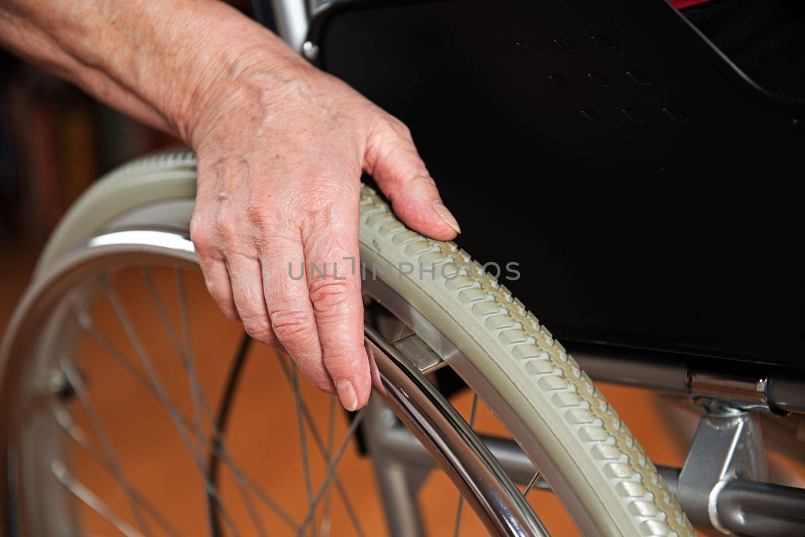 Old hand on the wheelchair
