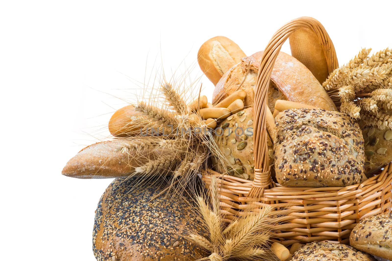 Still life about a basket with a large bread assortment isolated over a white background
