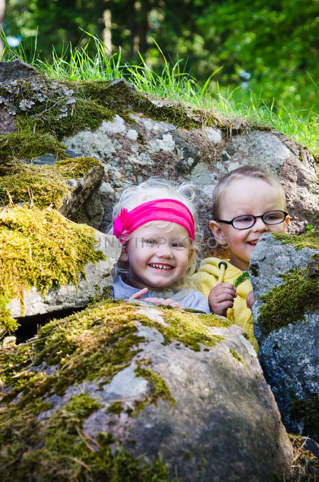 Young children, the boy with the girl hid among the rocks