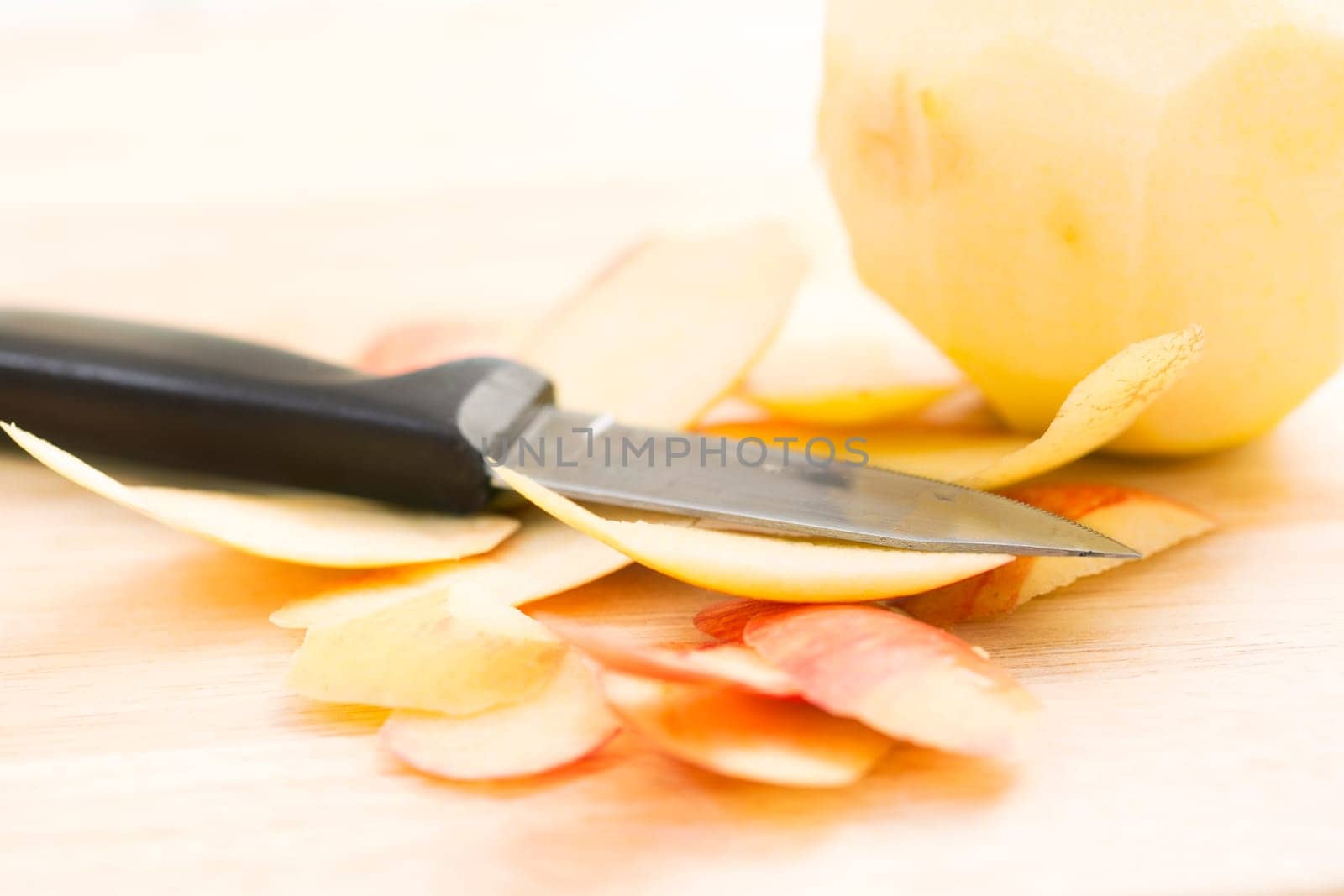 Apple peels with paring knife, shallow depth of field