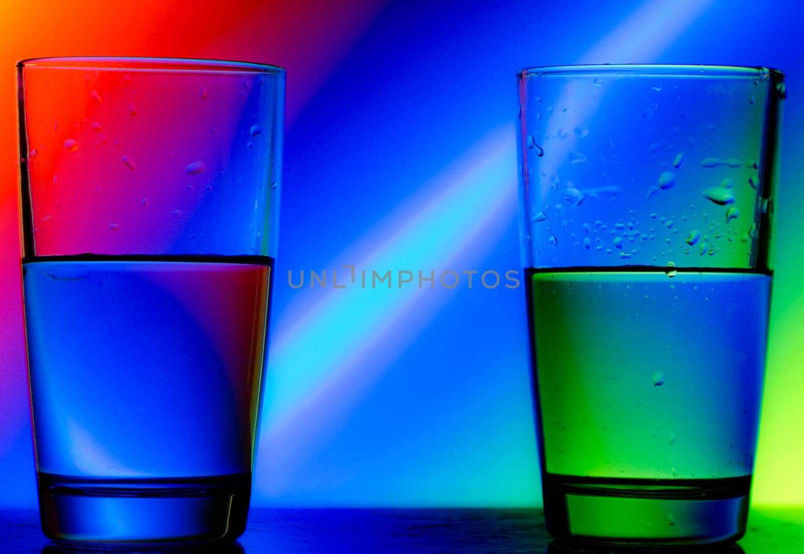 reflection of red green blue on a cup of water