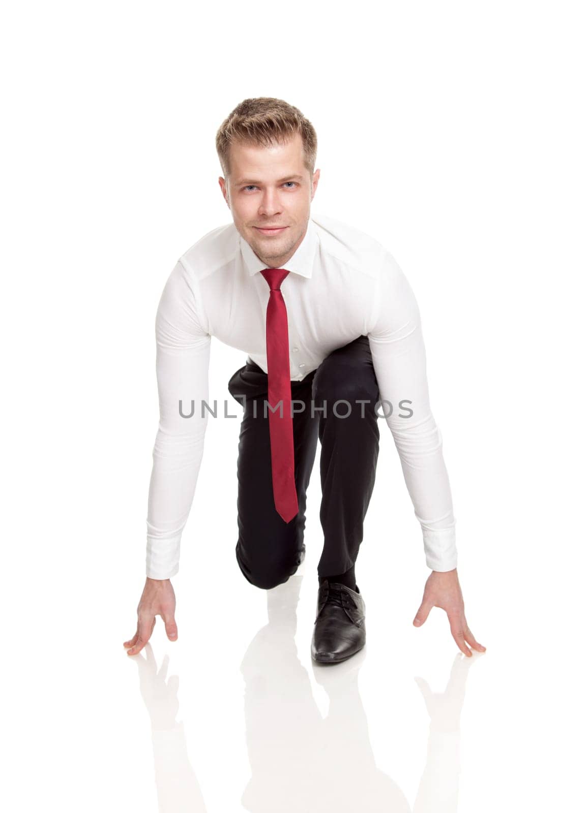 Businessman in starting position ready for chasing deals