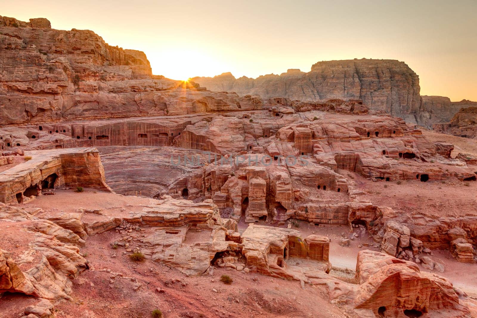 High view point of Petra tombs and amphitheater at sunset