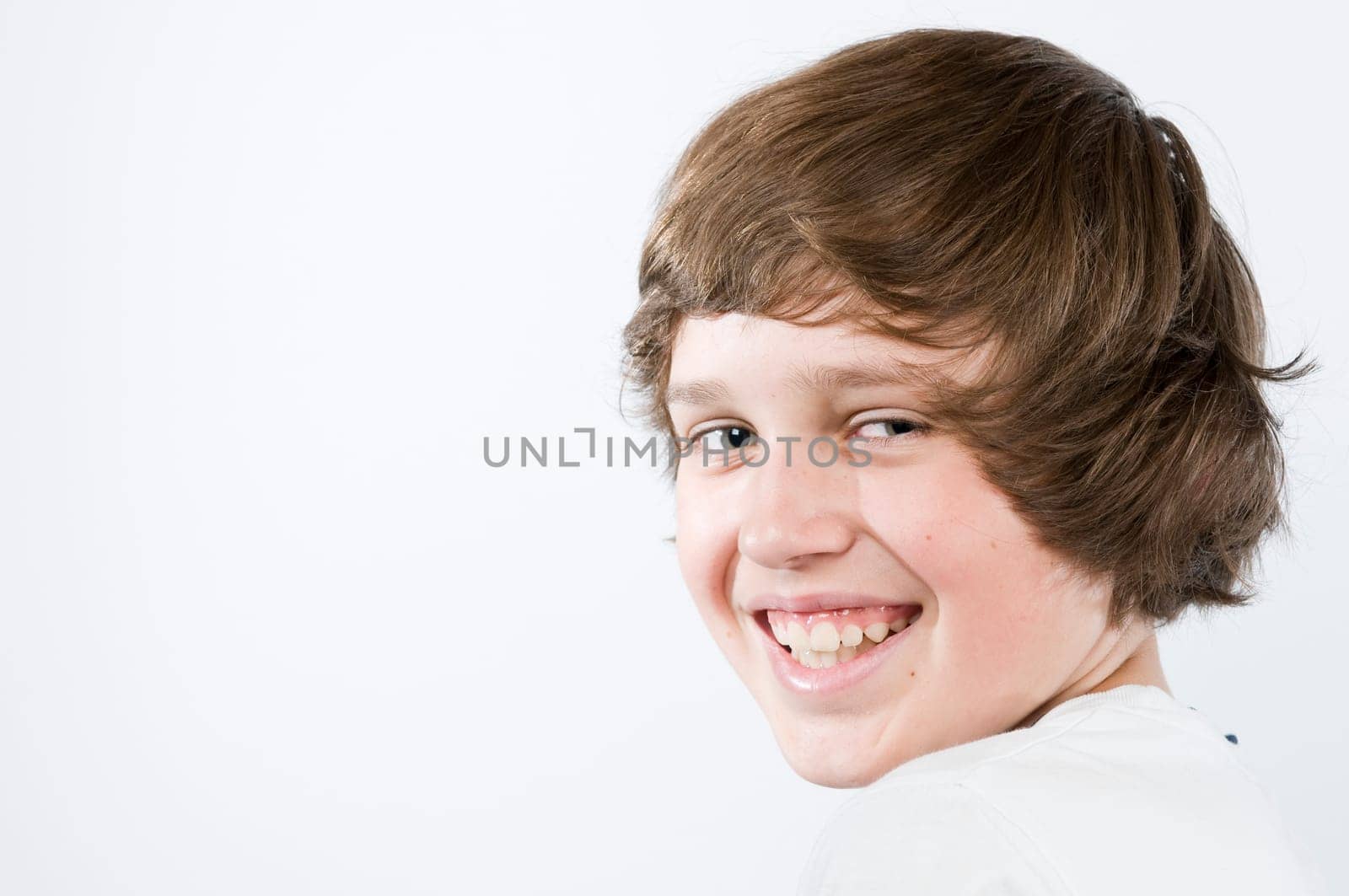 Head-and-shoulders portrait of a male teenager against a white background