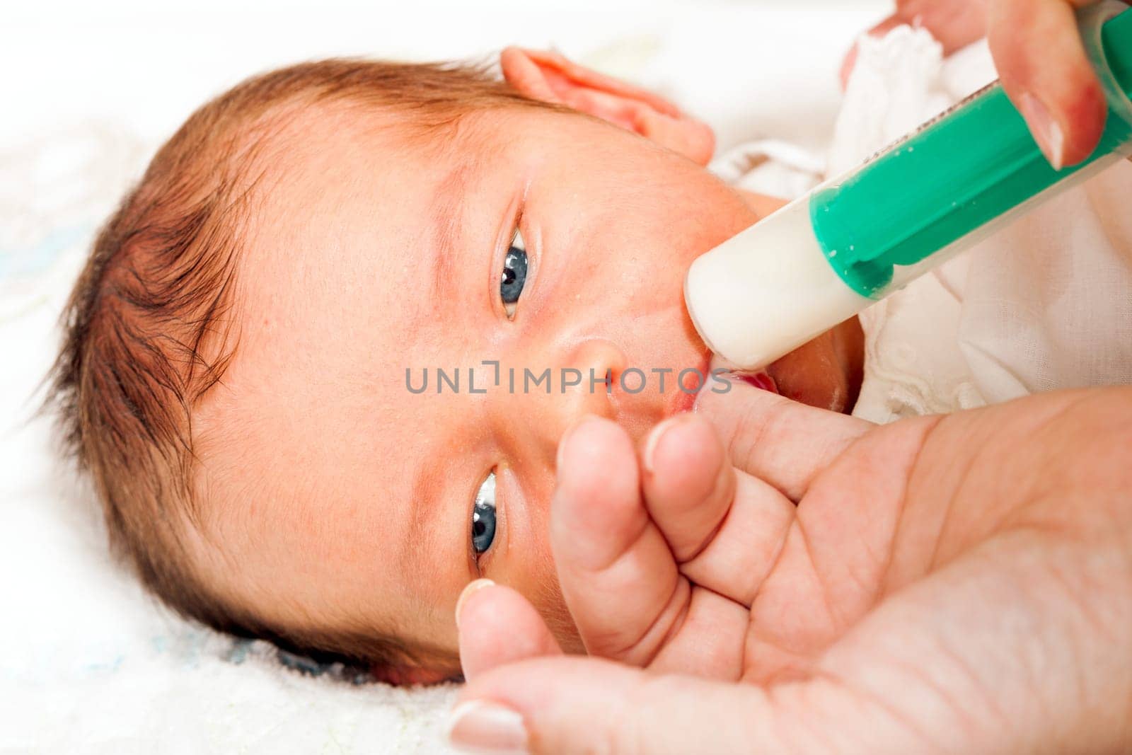 Little Boy Drinking Milk From The Mother Of The Syringe
