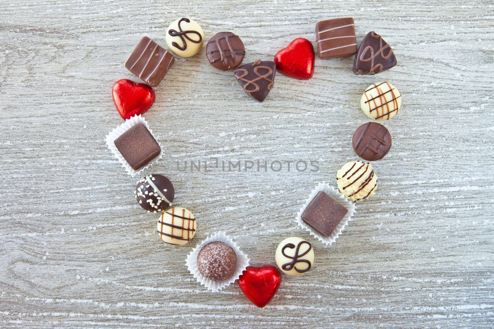 Heart shape made of various pralines and chocolates