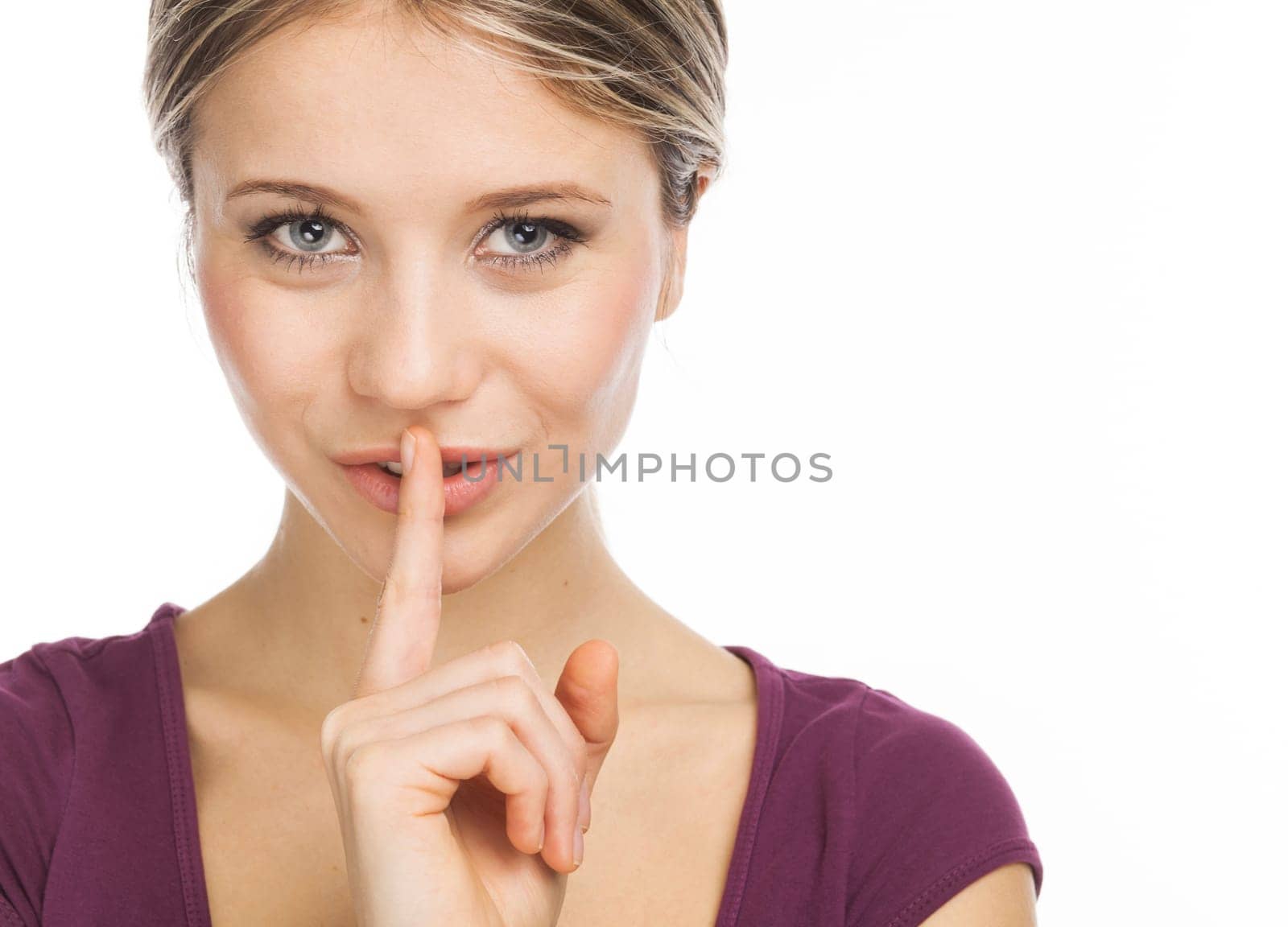 Close up portrait of a nice woman expressing a desire for silence or secret, on white