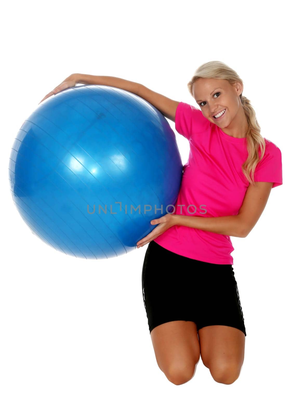 Beautiful woman holding a big blue exercise ball
