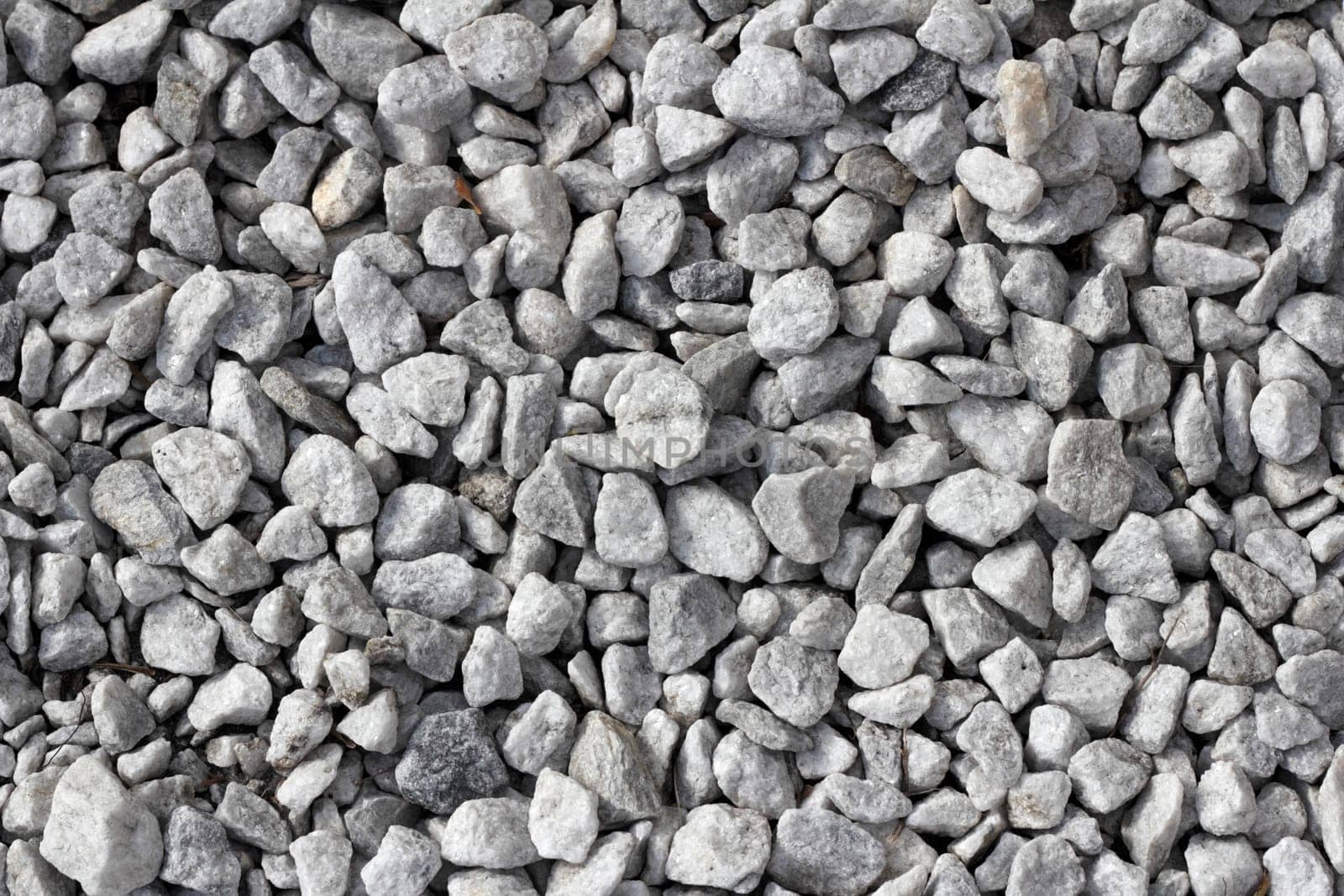 Gray white stones that act as gravel for drainage in flowerbeds and plantings in a wide variety of landscape areas.