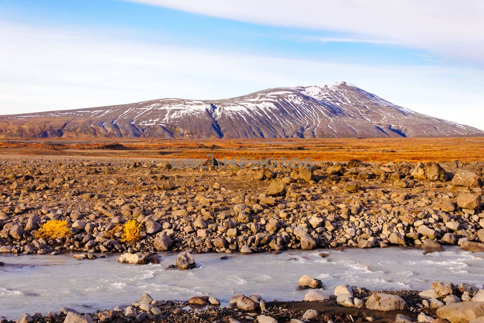 Icelandic landscape with volcanic rocks and green grass
