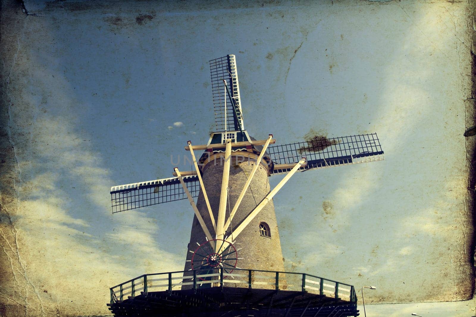 Vintage photo of dutch windmill under the blue sky of Netherlands