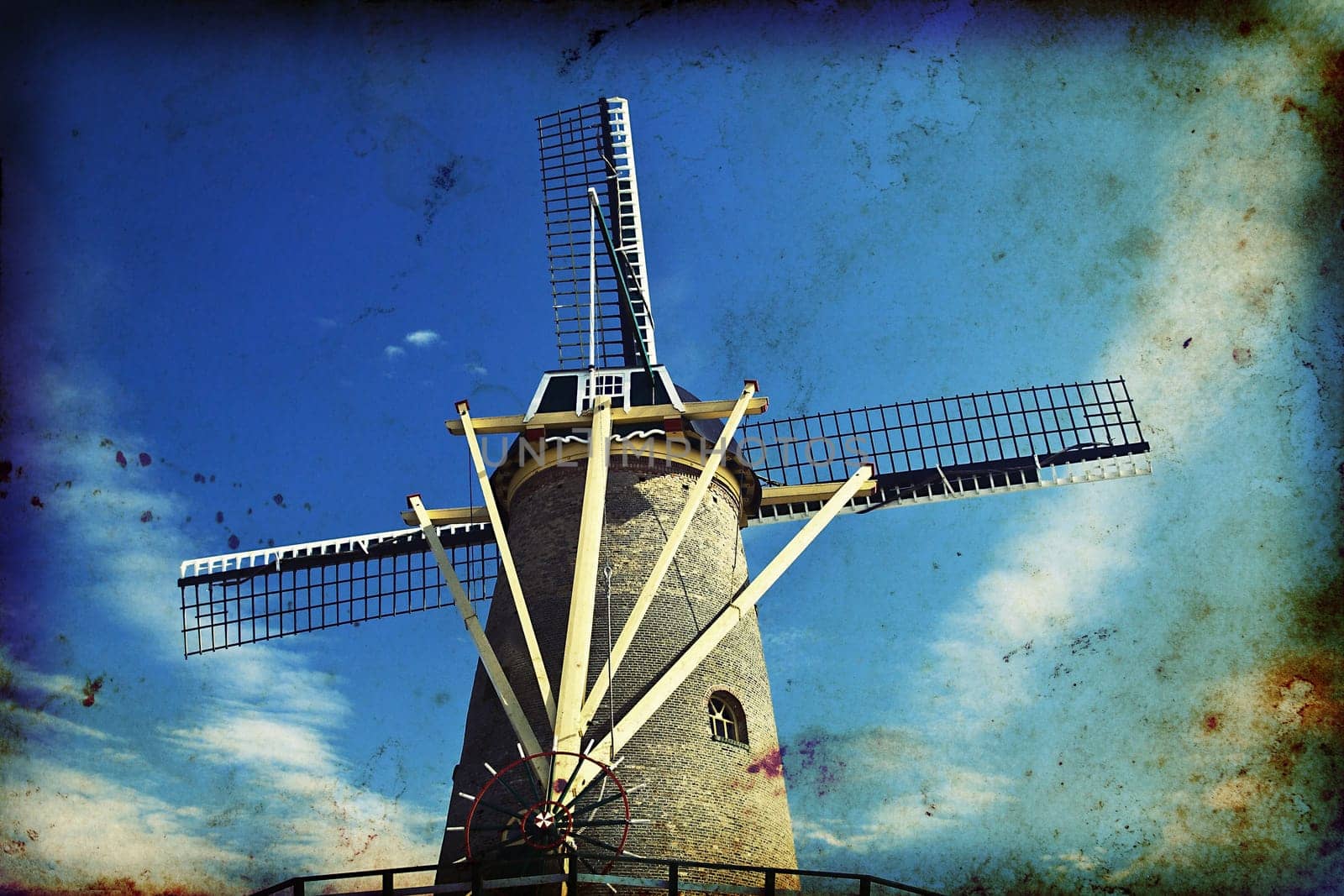 Vintage photo of dutch windmill under the blue sky of Netherlands