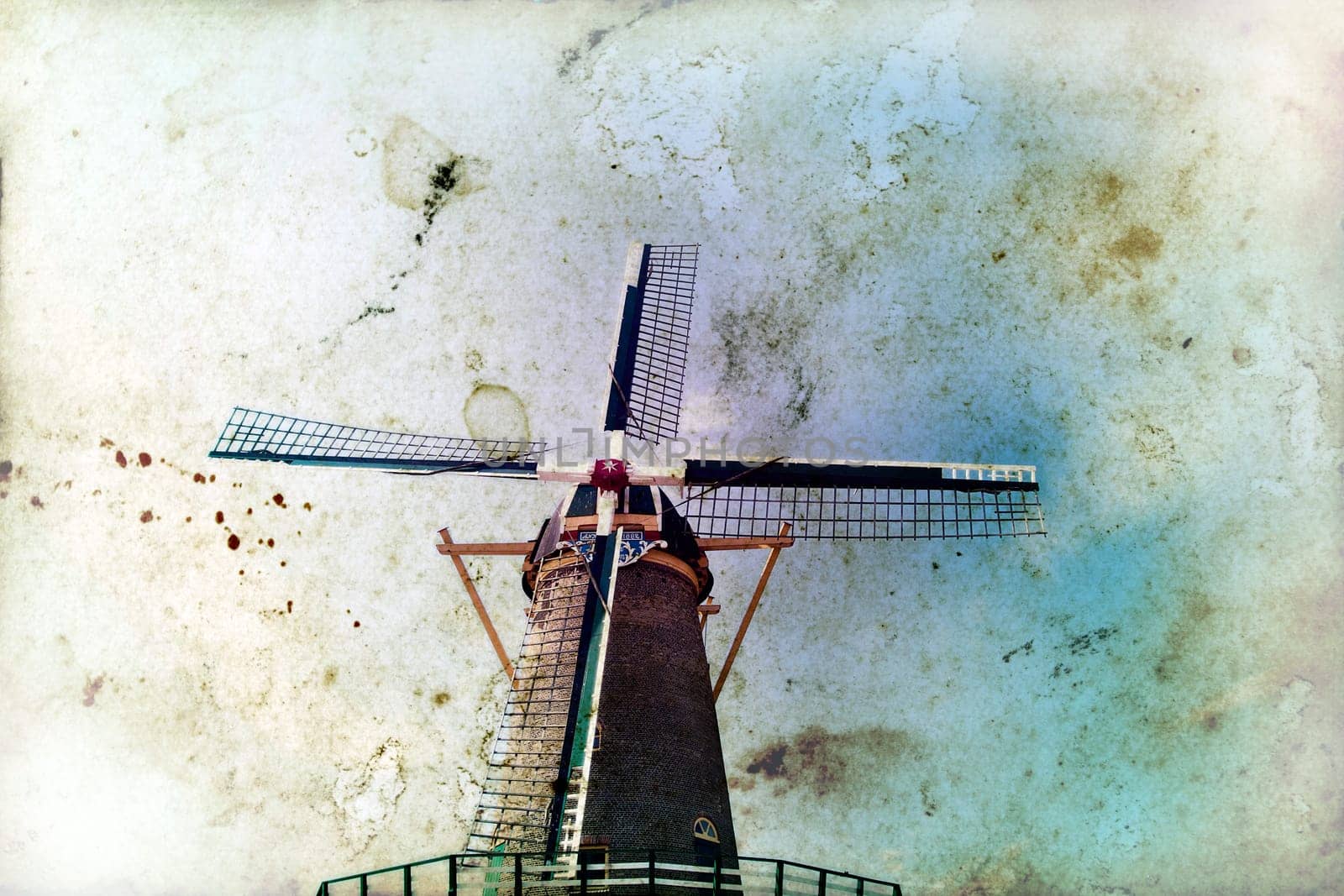 Vintage photo of dutch windmill under the blue sky of Netherlands
