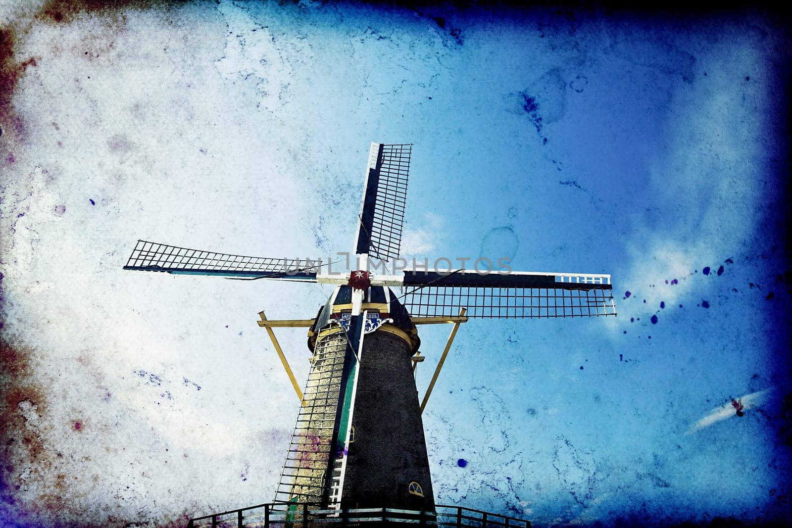 Vintage photo of dutch windmill under the blue sky of Netherlands