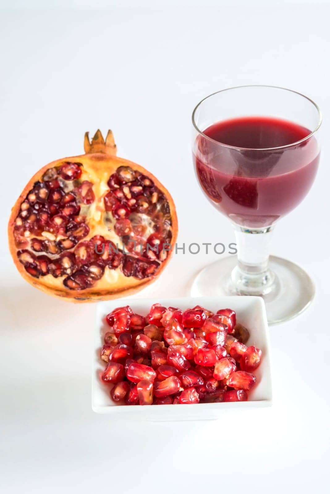 Pomegranate,halved fruit,seeds and juice