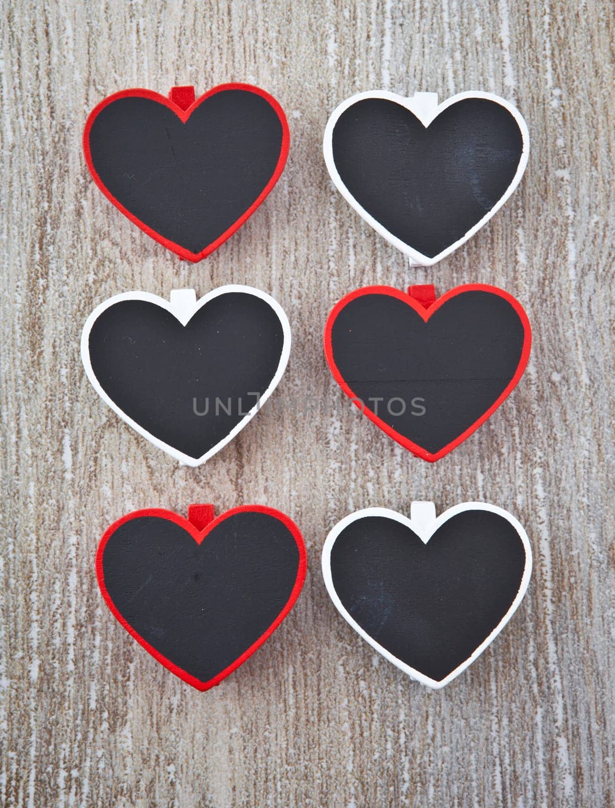 Small heart-shaped panels on a wooden background