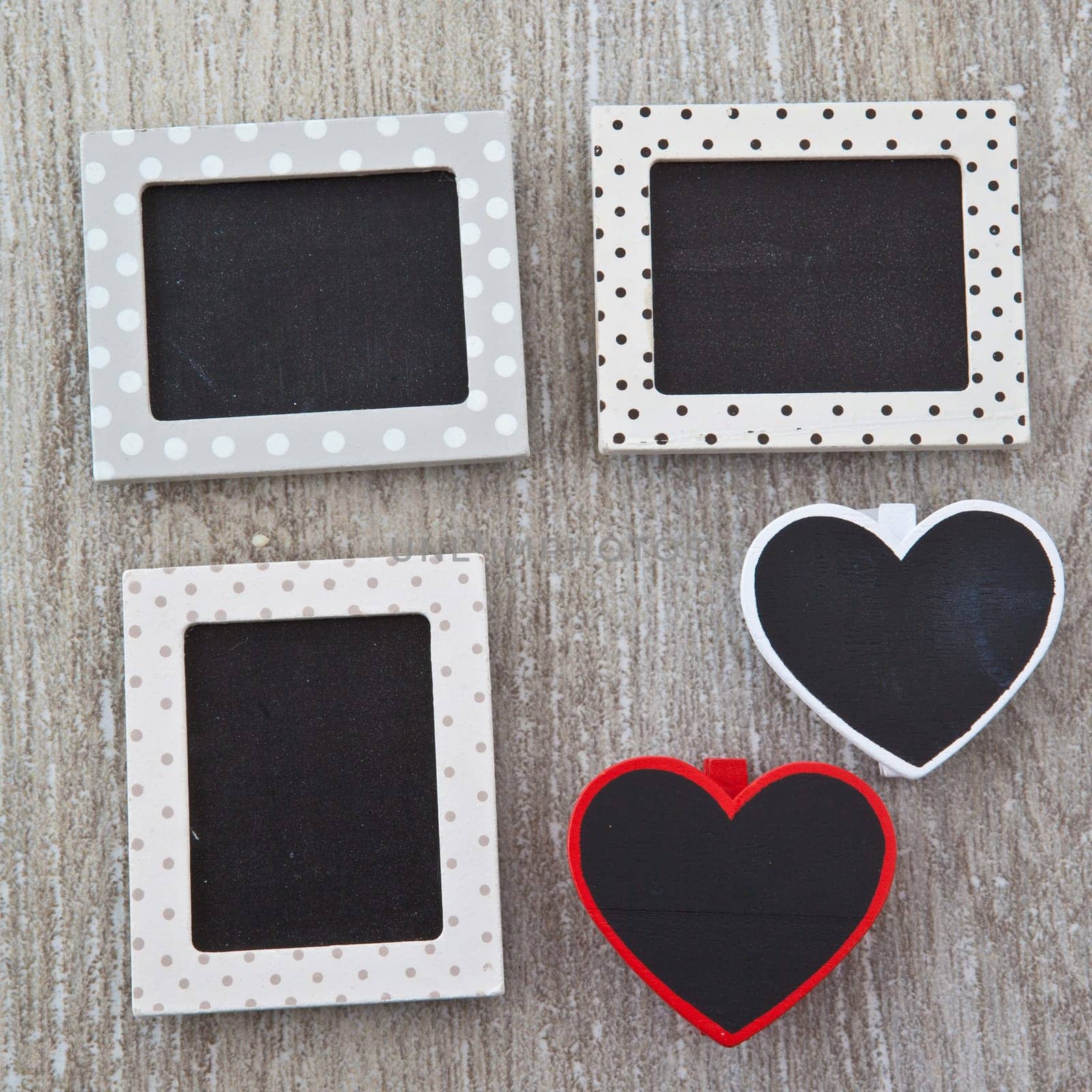 Small heart-shaped panels on a wooden background